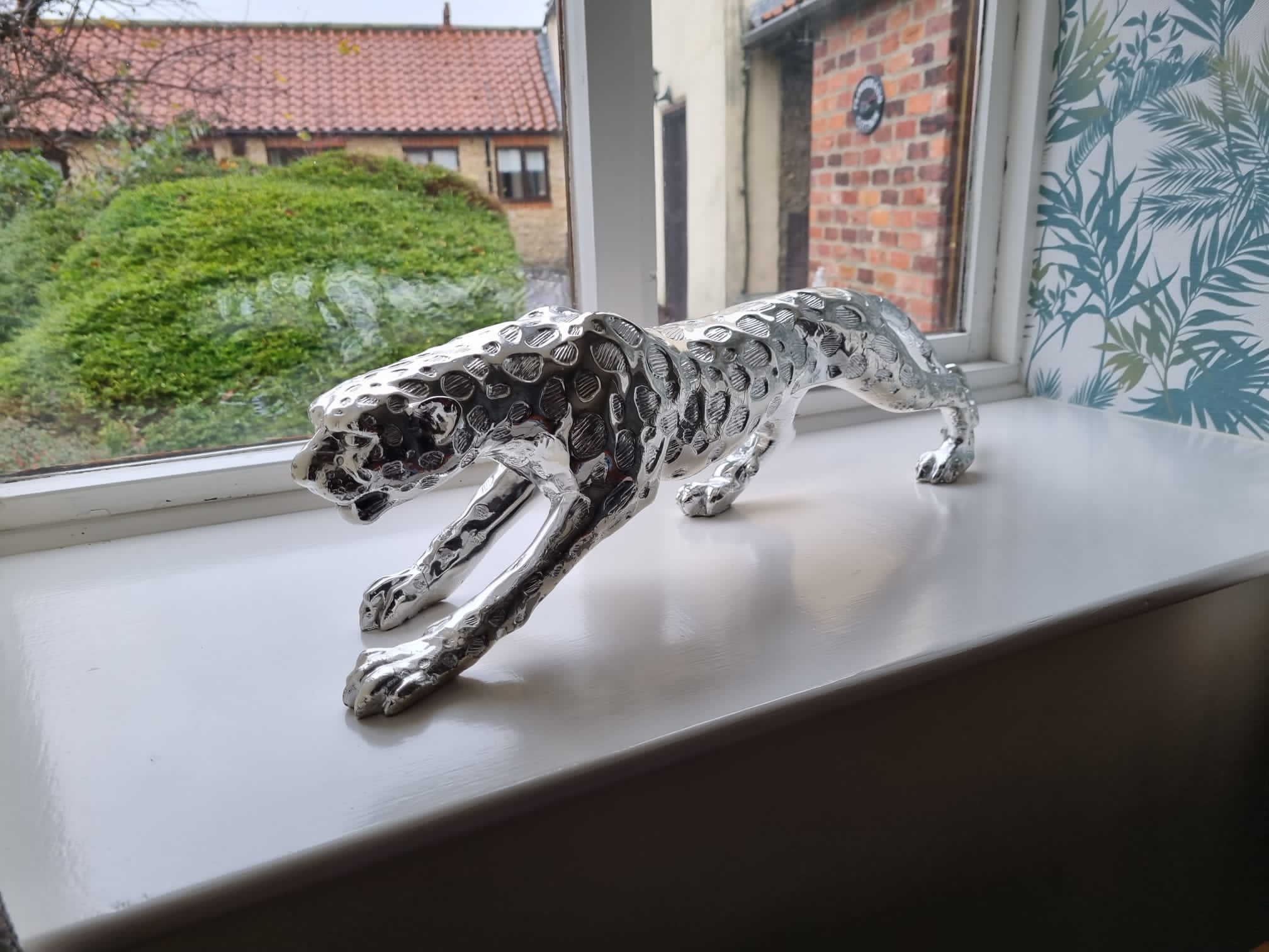 a jaguar sculpture in the window of Daleview cottage