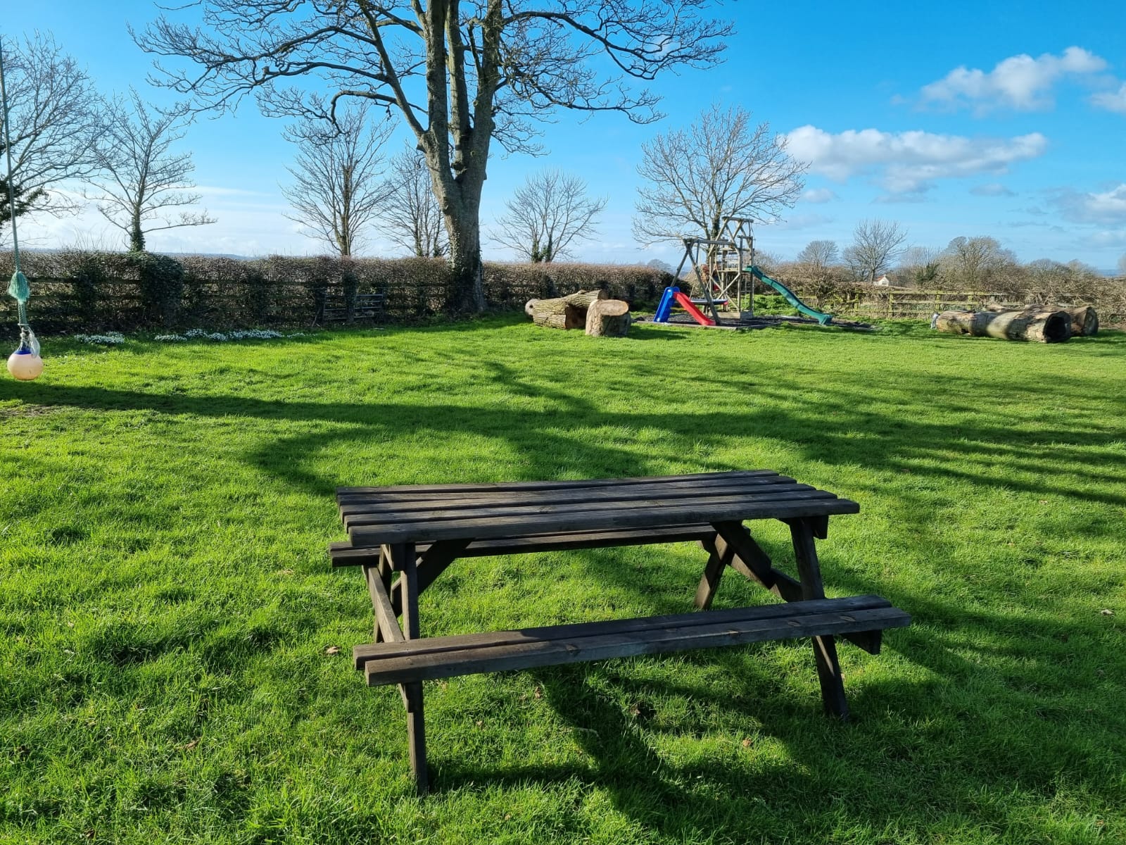 childrens play area with a bench in the foreground