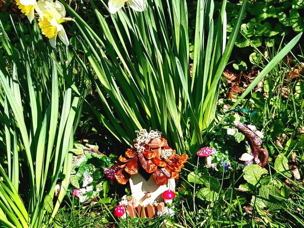 fairy house at the base of some flowers